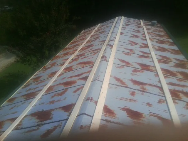 Rusted metal roof panels with new wood purlins before replacement — Storm Damage Roof Repair in Sunol by Roofing Brothers