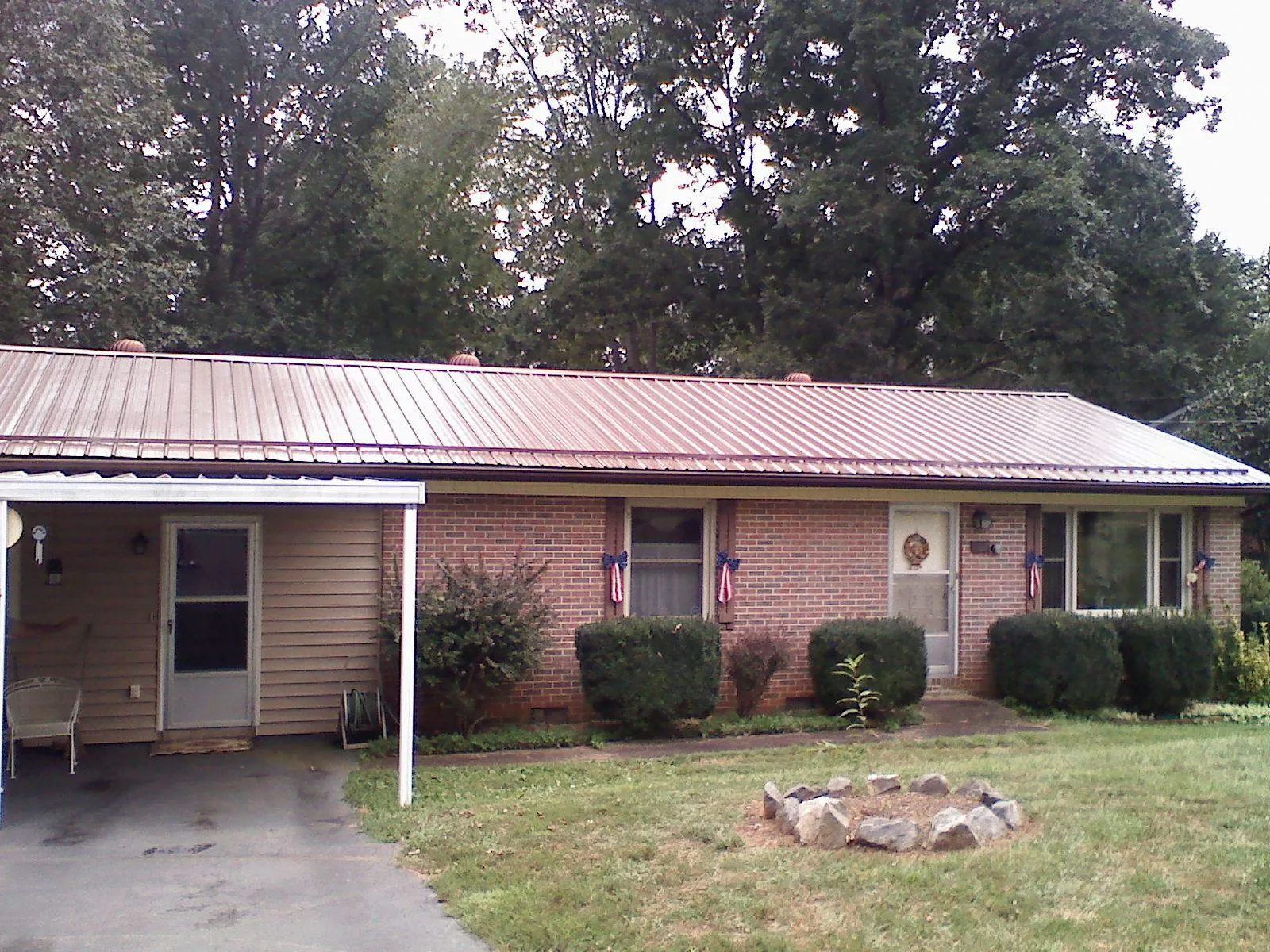 Bronze metal roof and carport on a brick ranch home — Roof Repair work by our crew in Sunol